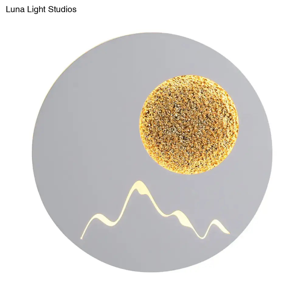 Textured gold circular wall light fixture with mountain silhouette in black white grey for bedroom fixture height