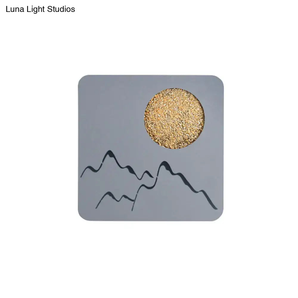 Gray square coaster with black mountain silhouettes and textured gold circle for black white grey wall light fixture height