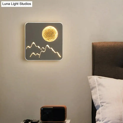 Square-shaped black white grey led wall light featuring a glowing golden sun and white mountain silhouette fixture height for bedroom