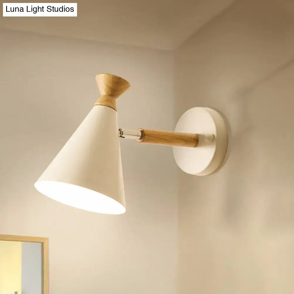 Minimalist wall light with white metal cone shade and light wood accents for bedroom reading use