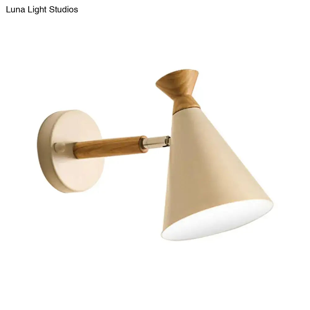 Beige conical wall light with natural wood arm and base and sleek metallic joint featuring metal cone shade design