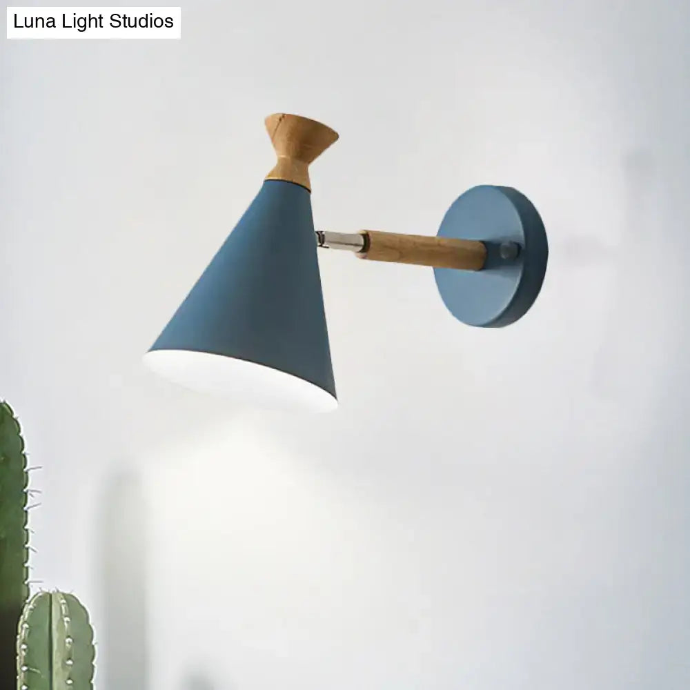 Blue nordic wall light with metal cone shade and wooden handle designed as a bedroom reading lamp