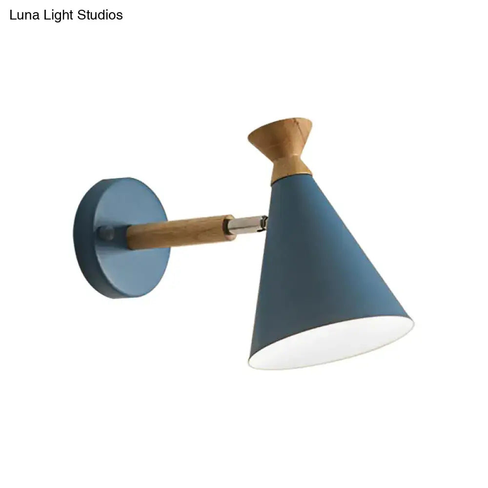 Blue conical wall light with metal cone shade and wooden arm base featuring a matte finish for bedroom reading lamp