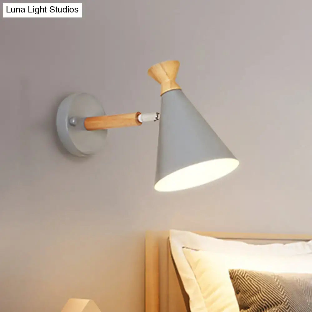 Gray conical wall light with metal cone shade and wooden arm featuring minimalist Nordic blue design for bedroom reading