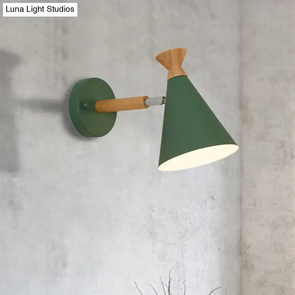 Green conical wall light with a wooden arm and base featuring a metal cone shade for bedroom reading use