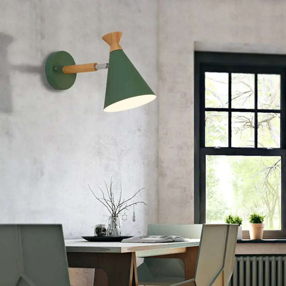 Green conical wall light with metal cone shade and wooden arm suitable for bedroom reading lamp use