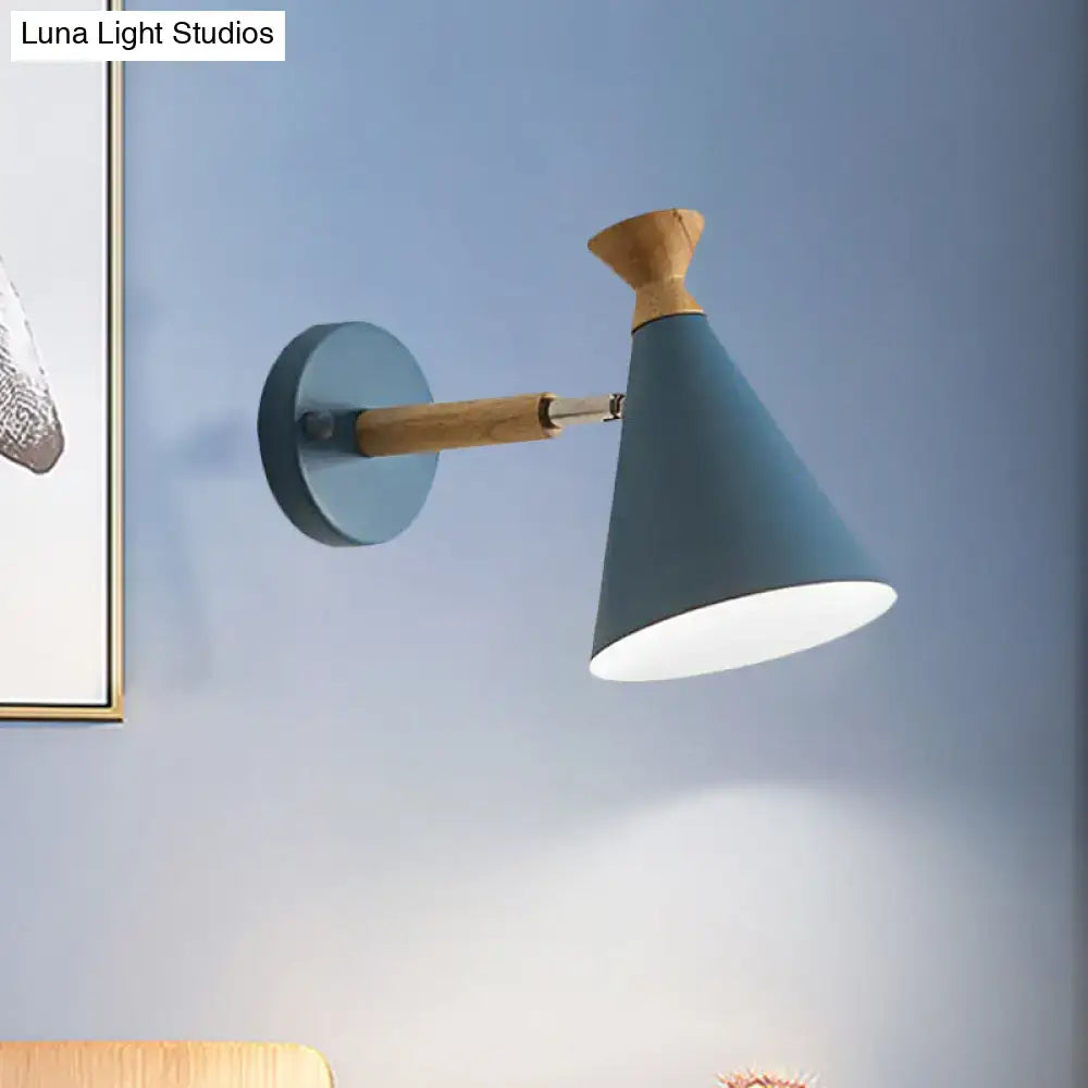 Modern teal metal wall light with wooden arm and metal cone shade ideal for bedroom reading lamp
