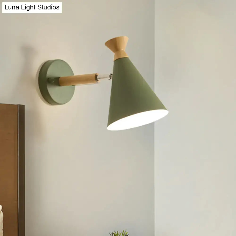 Olive green conical wall light with metal cone shade and natural wood accent featuring an adjustable arm for reading