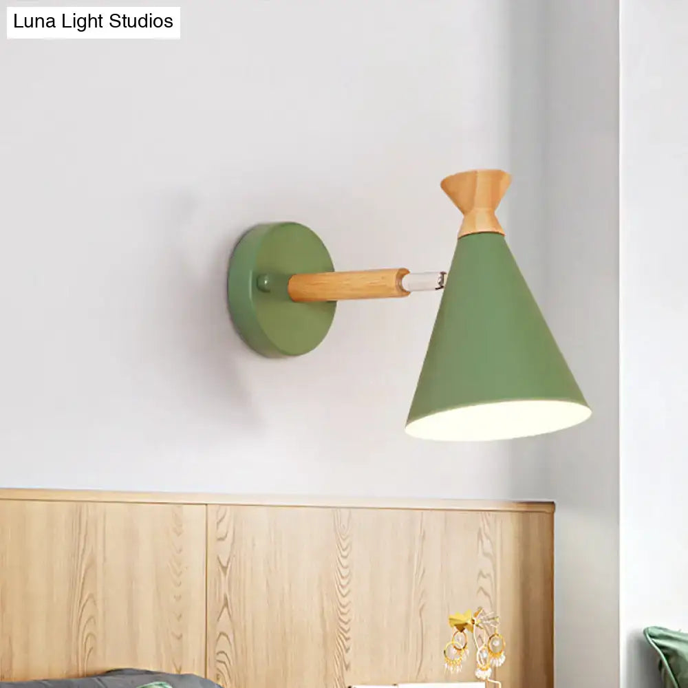 Olive green conical wall light with metal cone shade, natural wood accent, and metal arm for bedroom reading
