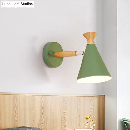 Olive green conical wall light with metal cone shade, natural wood accent, and metal arm for bedroom reading
