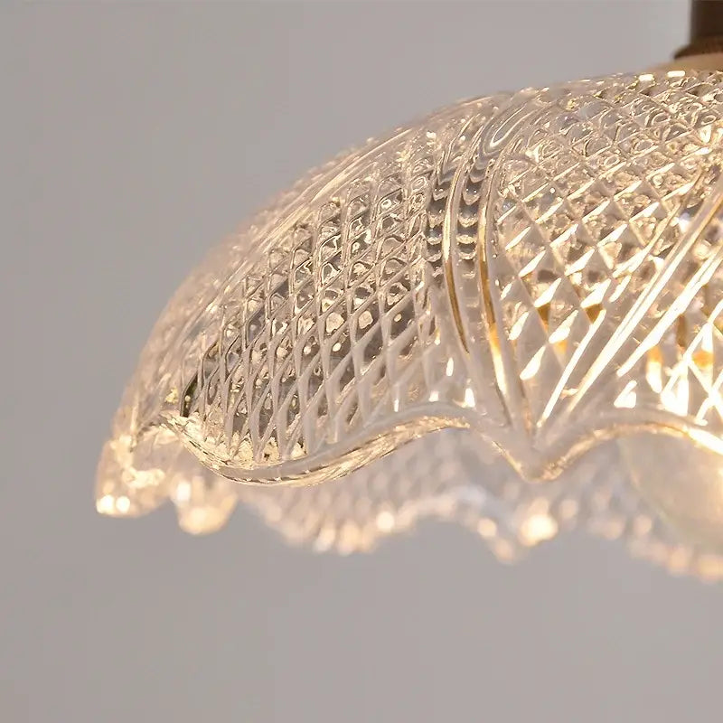 Nordic brass and clear glass led pendant light with intricate diamond-cut patterns and scalloped edge for dining rooms
