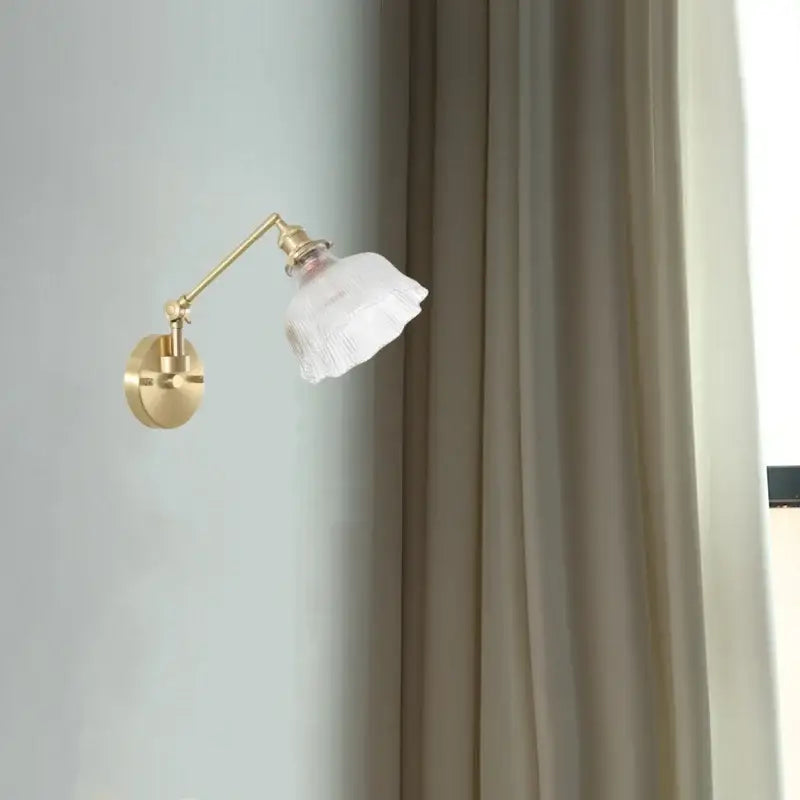 Gold-toned adjustable nordic brass wall sconce with frosted clear glass shade for bedroom decorbites clear glass