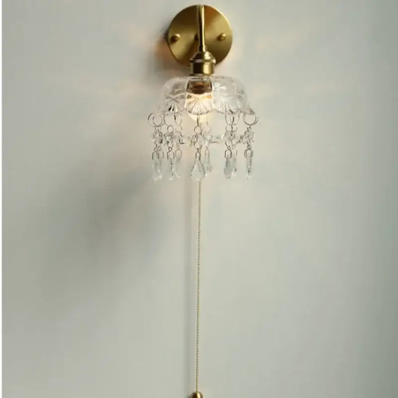 Nordic brass wall light with decorbites crystal glass led shade and dangling crystal droplets for bedroom decor