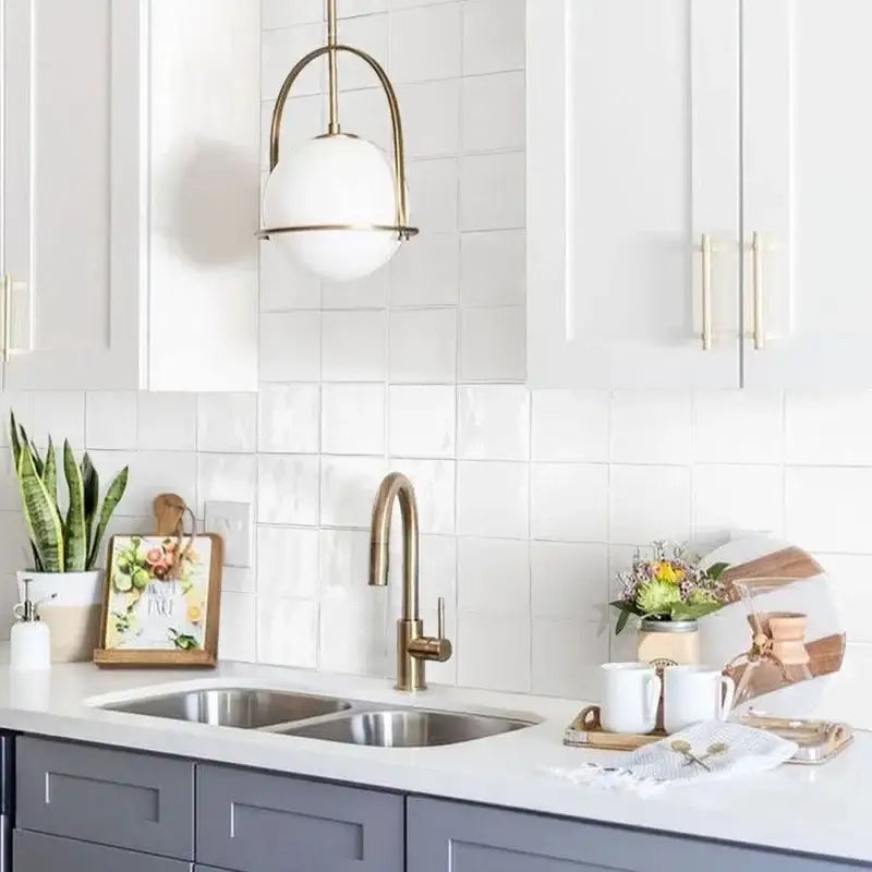 Brass gooseneck faucet with sleek curved spout and polished finish alongside nordic brass glass globe pendant light decorbites glass globe