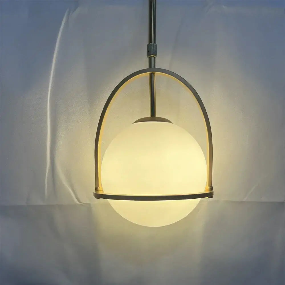 Nordic brass glass globe pendant light with warm frosted glass globe and sleek brass arch frame for kitchen decorbites pendant light