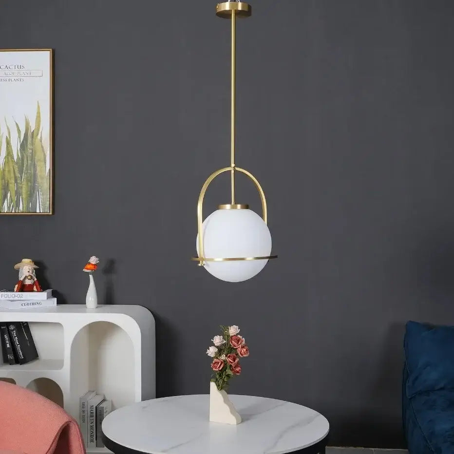 Modern nordic brass glass globe pendant light with gold-toned metal frame and frosted white shade for kitchen decorbites