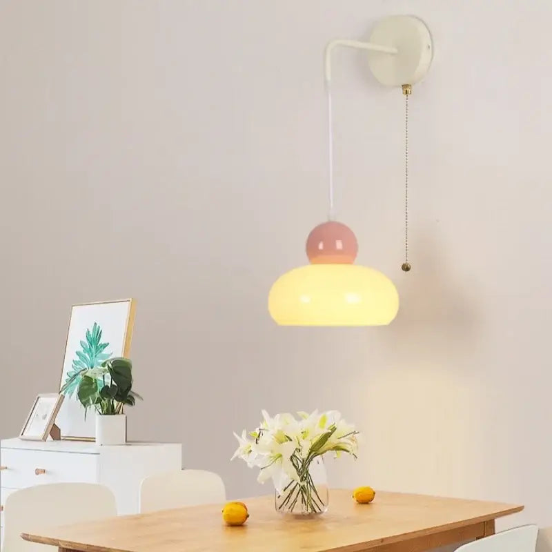 Pastel pink and yellow ceramic nordic cream wall light fixture with curved white iron mount by decorbites for bedroom decor