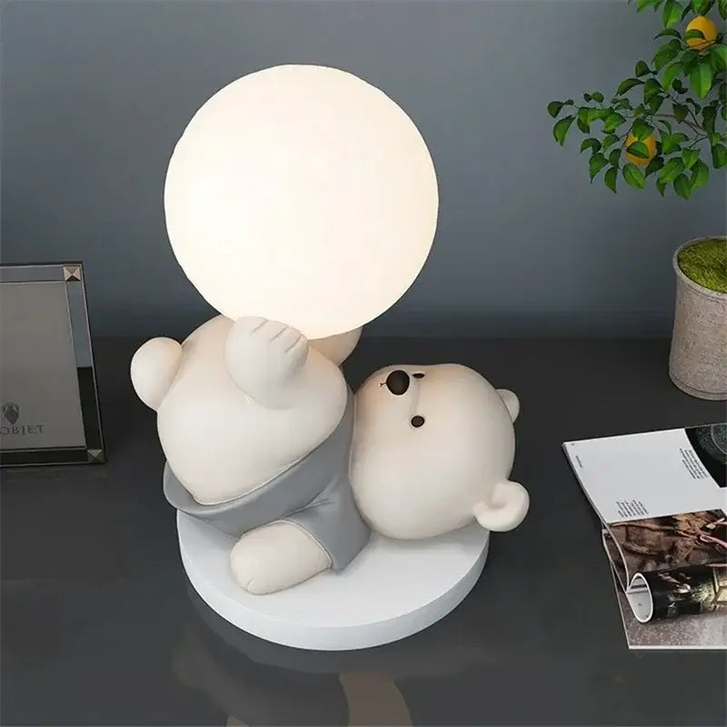 Nordic cream ceramic bear table lamp featuring a soft glowing spherical light held by a white bear figure