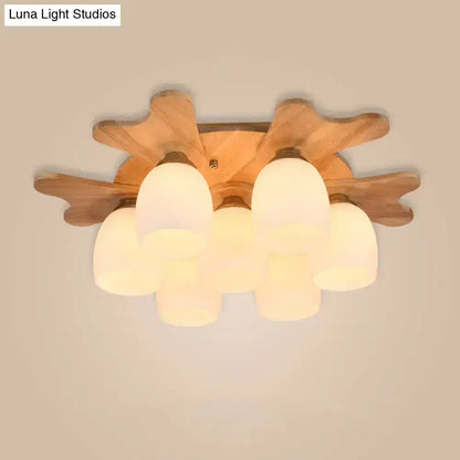 Wooden leaf-shaped ceiling light with five cream glass bell frosted shades for bedroom lighting