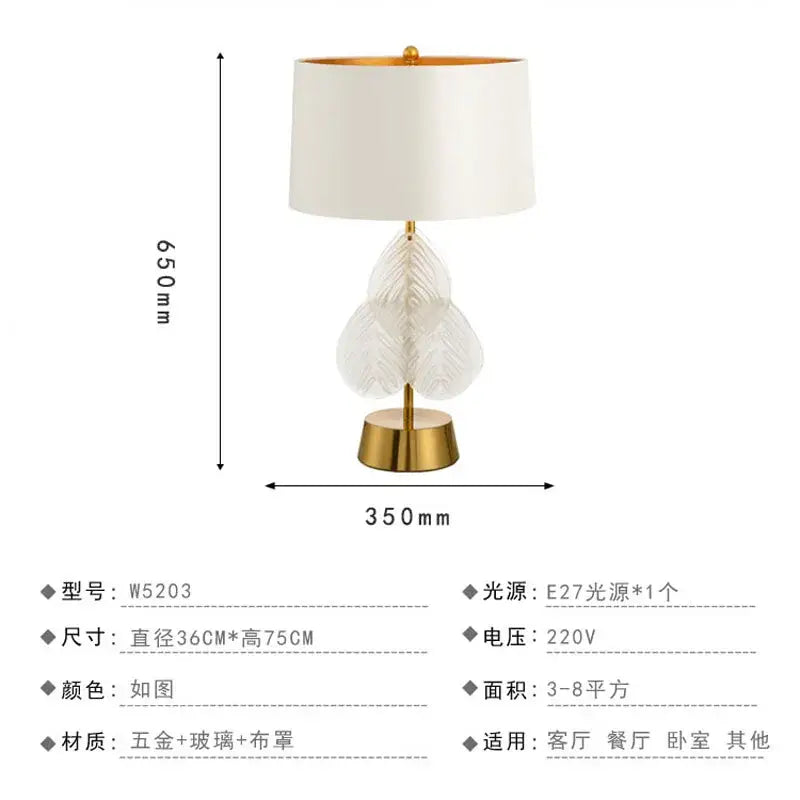 Elegant white lampshade crystal table lamp with gold-finished brass base and glass leaf centerpiece for bedroom use