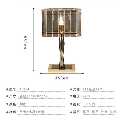 A nordic crystal table lamp with a rectangular faceted glass shade and gold-toned brass base for bedroom use