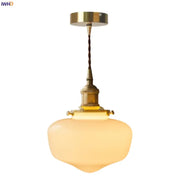 A nordic frosted glass led pendant lamp with brass metal fixture and twisted cord ideal for bedroom lighting