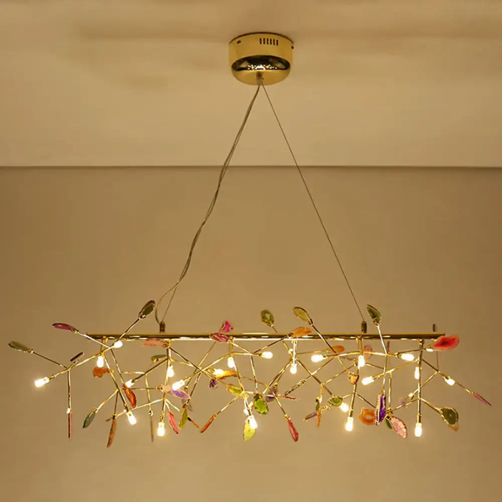 A modern nordic gold ceiling light with colorful glass leaves and warm led lights for dining room chandelier
