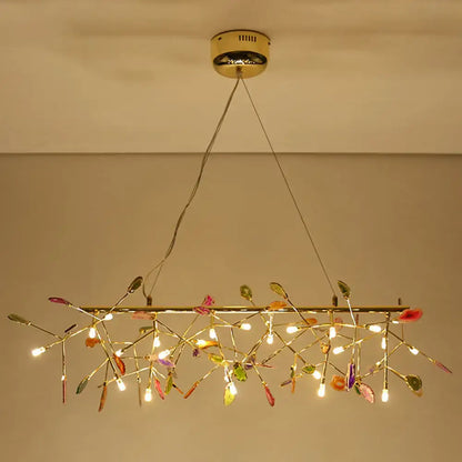 A modern nordic gold ceiling light with colorful glass leaves and warm led lights for dining room chandelier
