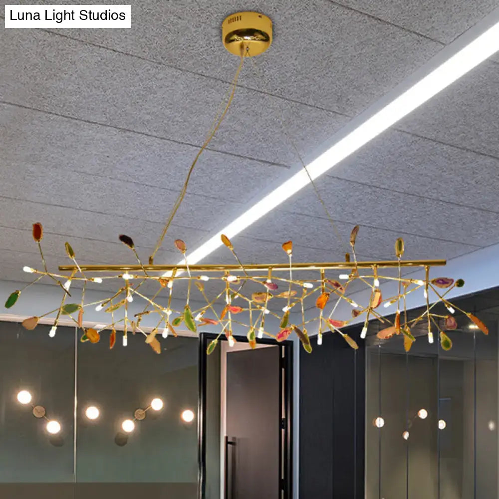 A modern nordic gold ceiling light dining room chandelier with colorful glass leaf accents and embedded led bulb base