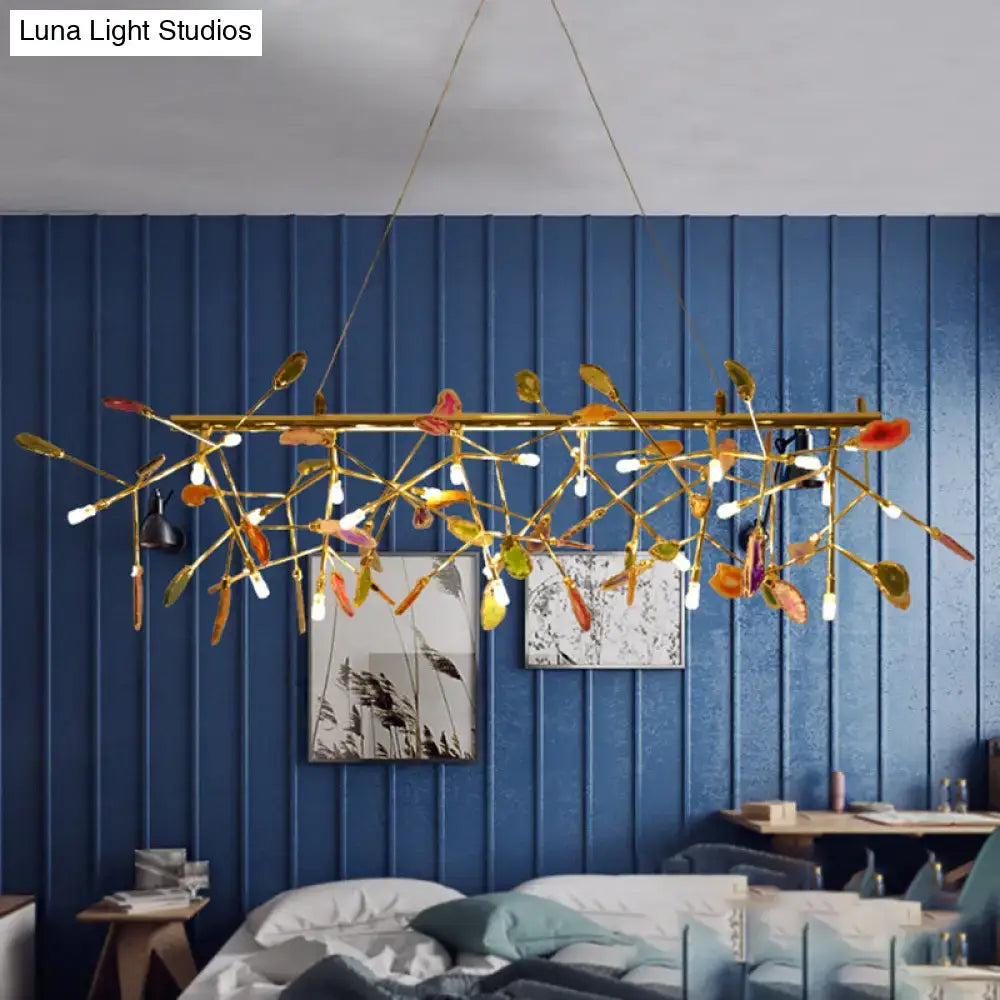 Gold-toned leaf-inspired ceiling light with colorful translucent leaves and exposed bulb base for dining room chandelier