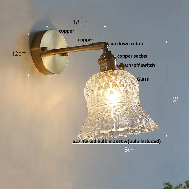 Antique brass-finished decorbites brass led wall sconce with faceted clear glass shade and adjustable arm for bedroom light