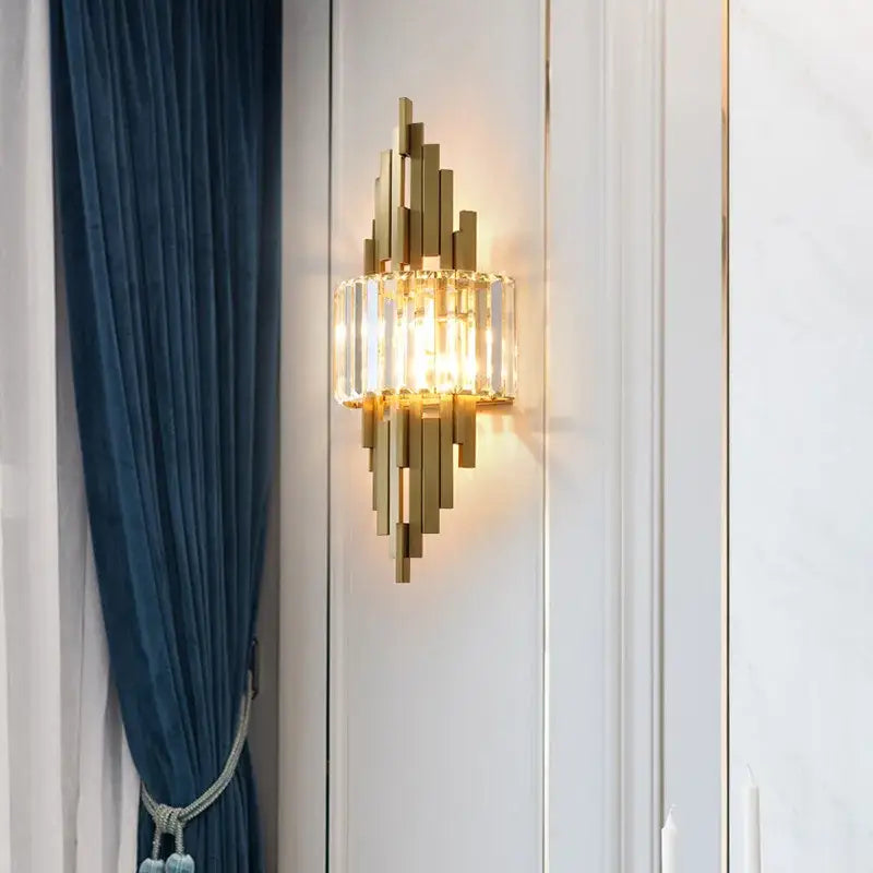 Gold-toned nordic crystal wall sconce with vertical crystal bars and central glass panel for living room decorbites crystal wall