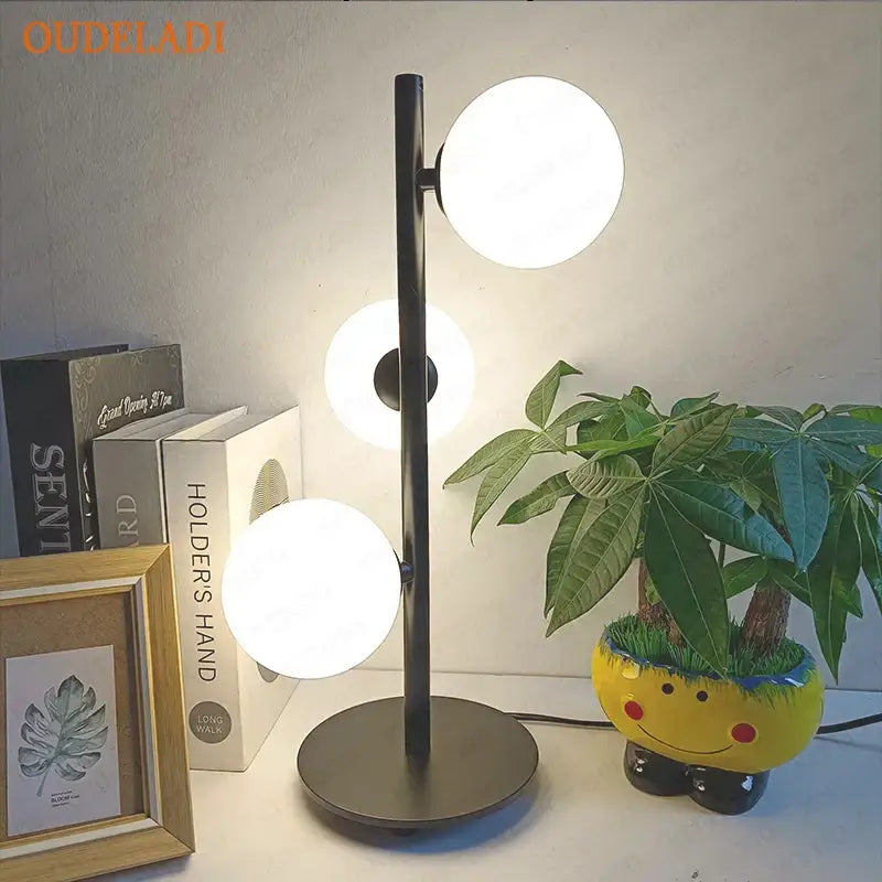 Modern black metal table lamp with three glowing white spheres decorbites glass ball led for bedroom lighting