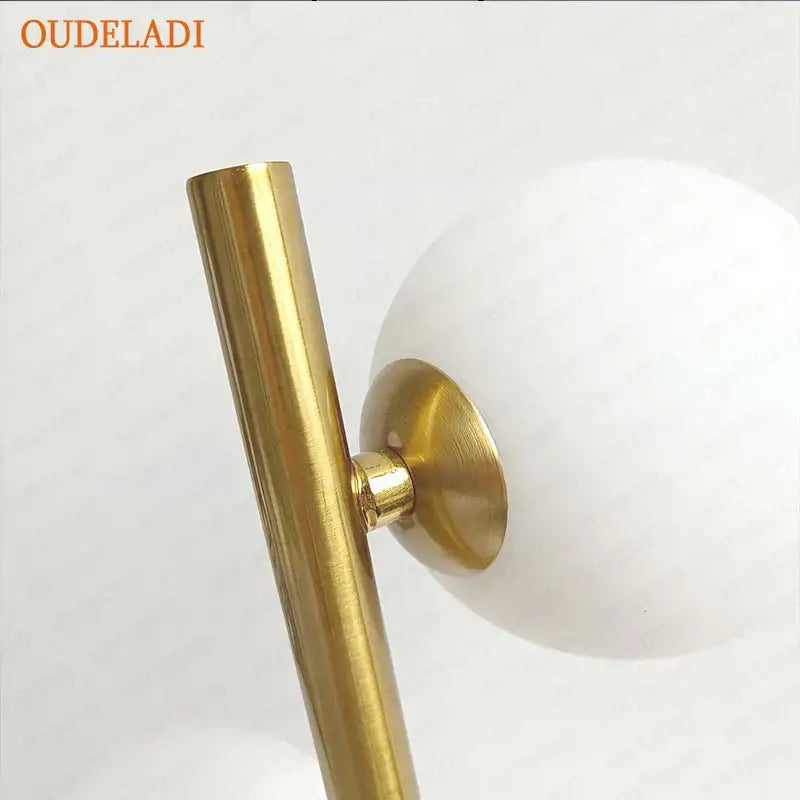 Nordic gold decorbites glass ball led table lamp with gold-toned metal stem and matte white spherical shade for bedroom