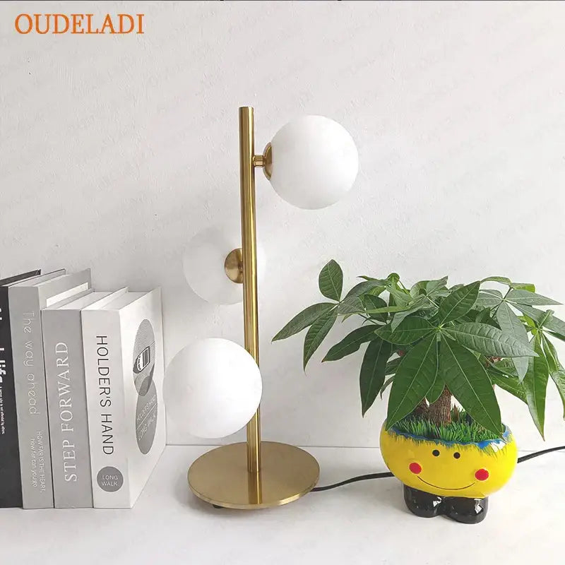 Gold-toned nordic decorbites glass ball led table lamp with three white glass shades for bedroom use