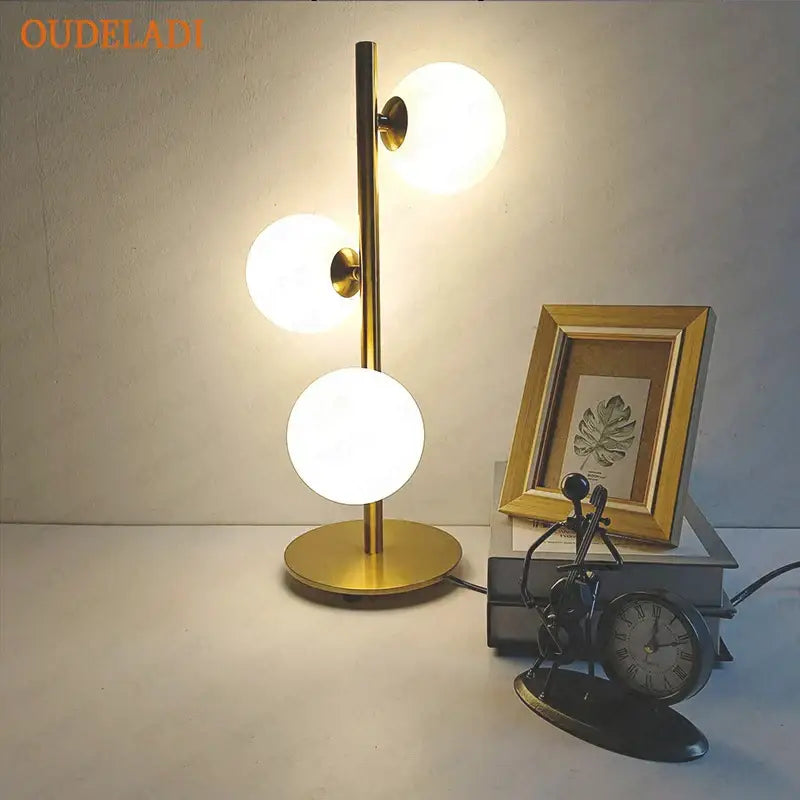 Nordic gold decorbites glass ball led table lamp with three frosted glass globes on a slender metallic stem for bedroom