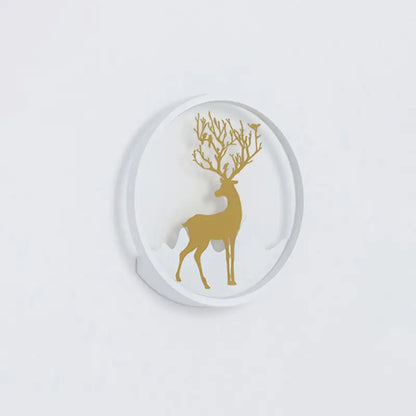 White circular coaster featuring a gold deer silhouette with antlers adorned by delicate branches and tiny birds.