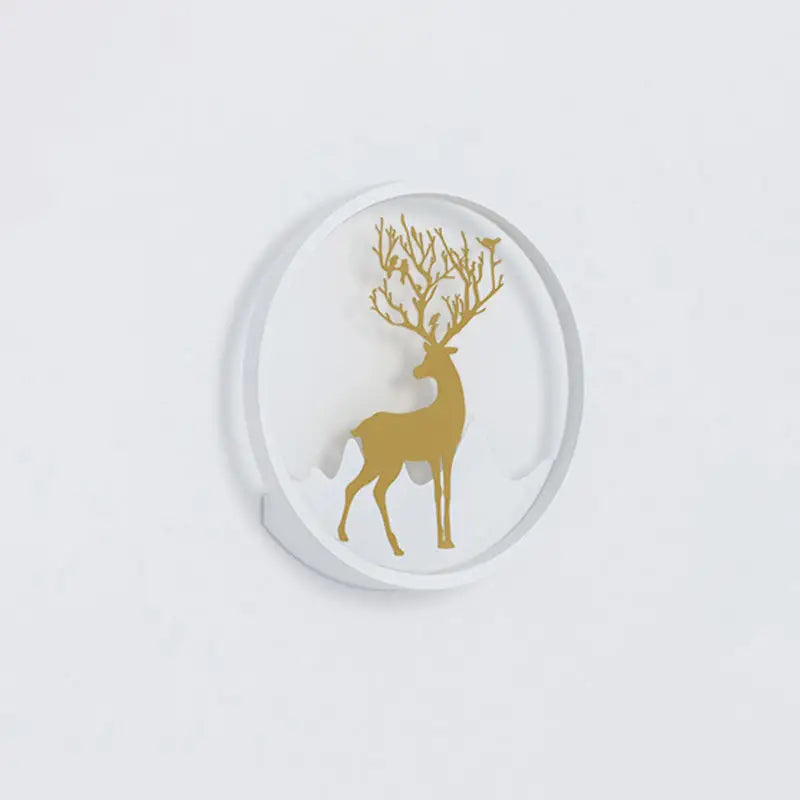 White circular coaster featuring a gold deer silhouette with antlers adorned by delicate branches and tiny birds.