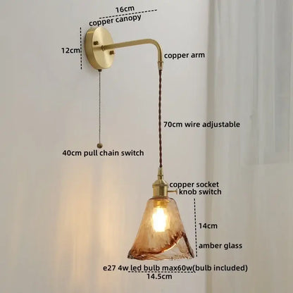 Copper wall sconce lamp with amber glass shade and adjustable arm featuring nordic gold etched glass and braided cord