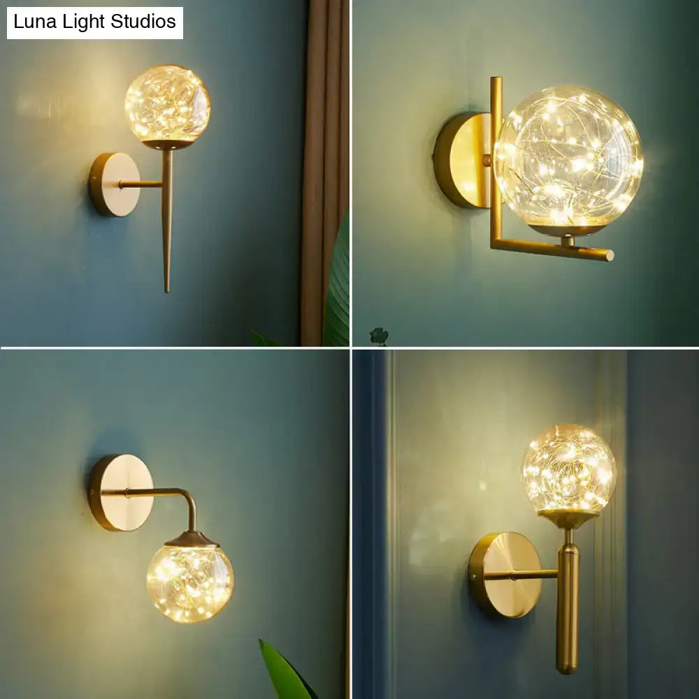 Nordic gold glass globe wall sconce with gold-toned metal and spherical glass housing warm bedroom fairy lights