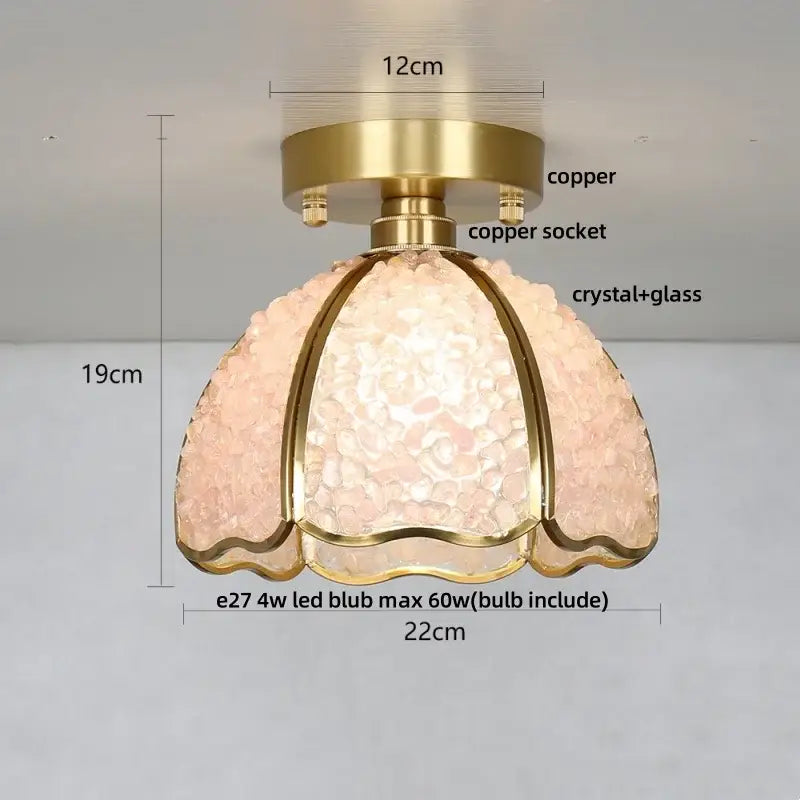 A delicate pink crystal glass ceiling light with brass copper finish and scalloped design for bedroom use