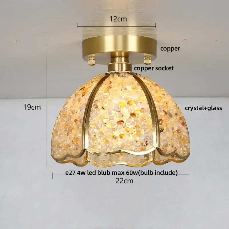 A warm-toned dome-shaped glass crystal ceiling light with copper base and amber clear mosaic shade for bedroom