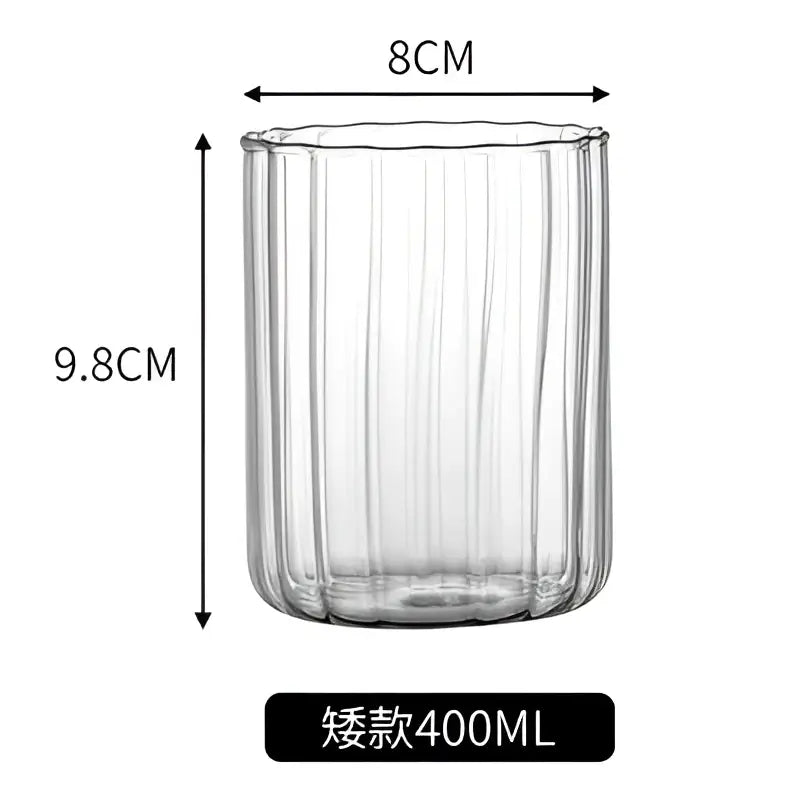 Clear glass ripple cup with vertical ribbed texture and gold leaf spoon for dining room use in nordic style