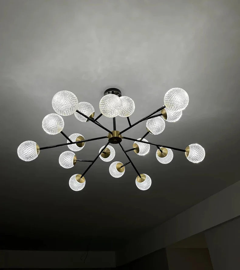 A modern nordic home decor chandelier with brass fixture black metal arms and white glass globes for dining room lighting