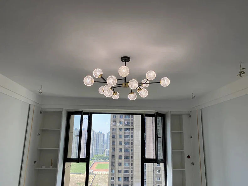 Modern chandelier with multiple spherical glass bulbs and dark metal frame for nordic dining room lighting