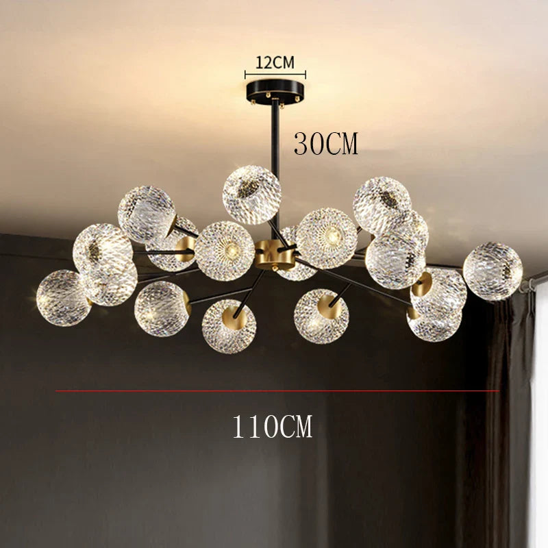 A modern Nordic dining room pendant lamp with clear textured glass spheres on a black and gold metal frame