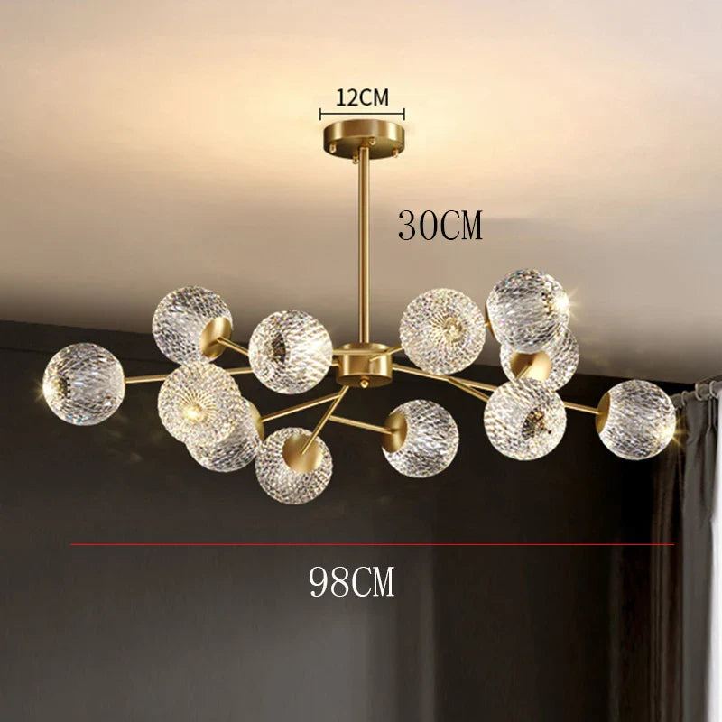 Gold-toned nordic pendant chandelier with clear textured glass spheres and brass fixture for dining room lighting