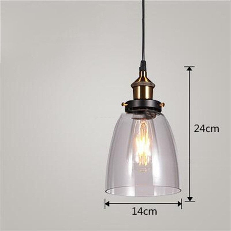 Clear glass pendant light with black metal accents and vintage edison bulb design in a nordic industrial glass chandelier