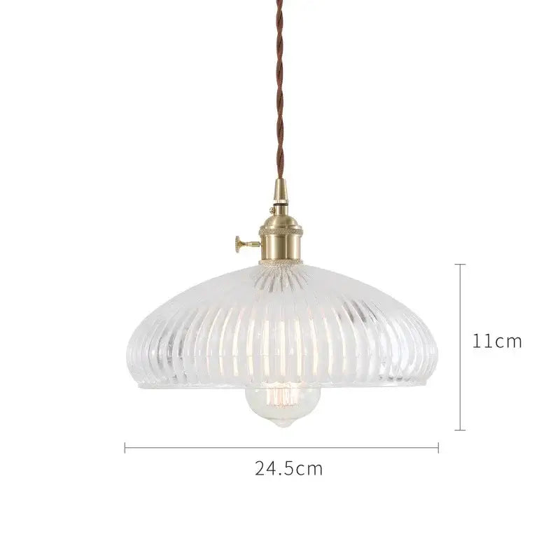Clear ribbed glass pendant light with brass fixture and twisted brown cord in nordic japan style for dining room