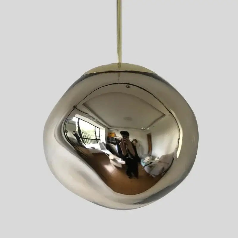 Shiny chrome spherical pendant light with gold-toned rod in decorbites nordic lava glass chandelier amber gold design